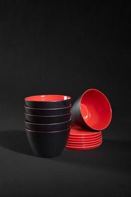 red and black bowls and cups on a black background