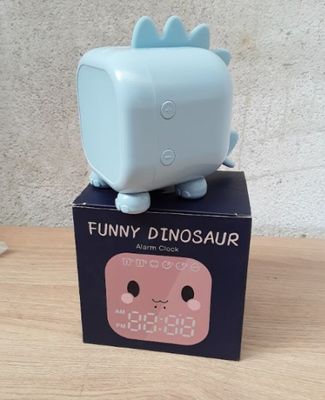 a small blue box with a small blue cat on top of it