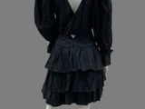 a mannequin wearing a black dress with ruffled skirt