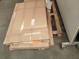 a large cardboard box sitting on the floor next to a pallet