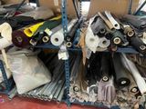 many rolls of fabric on the shelves in the warehouse