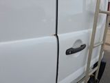 a ladder that is attached to the side of a white van
