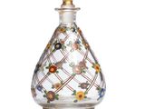an image of a glass perfume bottle with colorful flowers on it