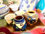 many different vases and plates on the table
