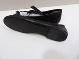 pair of black shoes on a white surface with a white background
