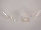 two empty wine glasses sitting on a white surface