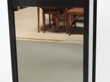 a mirror that has a reflection of a table in it