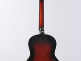 a close up of a guitar hanging from a string