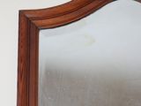 a mirror with a wooden frame on the wall