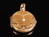 an image of a gold locke with a diamond in the center