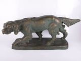 bronze statue of a dog on a base on a white background