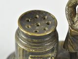 bronze figurine of a woman with a salt and pepper shaker