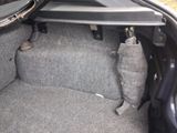 the interior of a car with the door open and the seat down