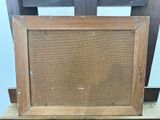 an old picture frame sitting on top of a wooden chair