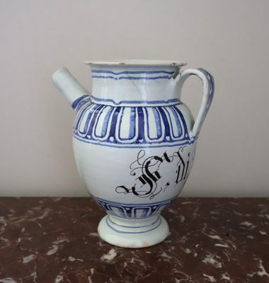 a blue and white vase sitting on a table