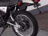 a black and white motorcycle parked in a garage