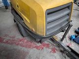 a yellow machine that is sitting in a garage