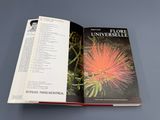 an open book with a picture of a pink flower on it