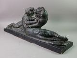 statue of a man and a woman laying down on a marble base
