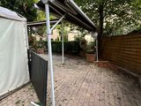 a tent that is sitting on the ground in the yard