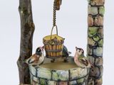 a figurine of a fountain with birds on top of it