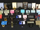 many different types of perfumes on a black surface