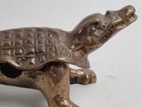 brass figurine of a turtle on a white background