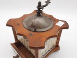 a coffee grinder sitting on top of a wooden table