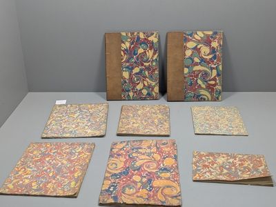 several notebooks and notebooks are lined up on a table