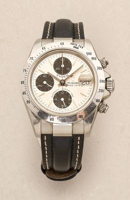 a watch that is sitting on a white surface