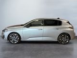 the silver car is parked in a room with a white wall