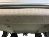 the interior of a car with the sunroof down and the dash light on