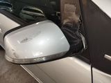 a side view mirror of a car with a glove on the side of it