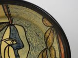 a plate with a painting of a face on it