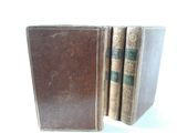 three old books that are sitting on a table