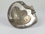 an image of a silver plate with a flower on it