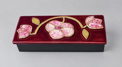 a close up of a box with flowers on it on a table