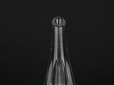 clear glass vase on a black surface with a black background