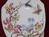 a picture of a plate with a bird and flowers on it