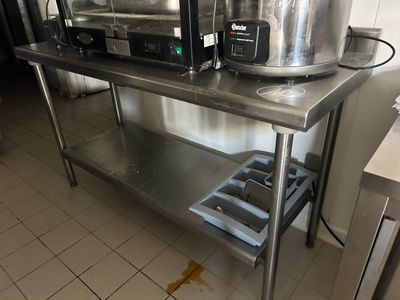 a stainless steel table with a pot on top of it