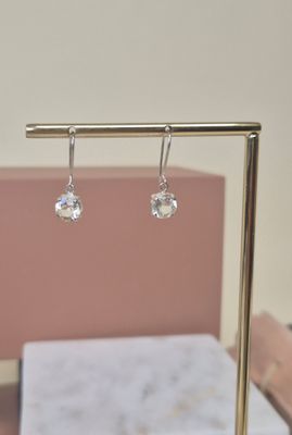 paire de boucles d'oreilles en cristal transparent suspendues à un support plaqué or