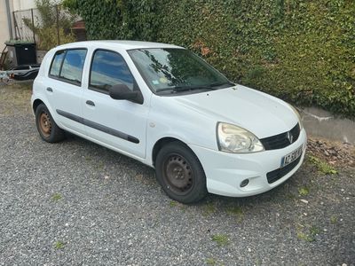 une petite voiture blanche garée sur le bord de la route