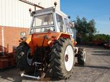 a tractor that is parked in front of a building