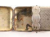 a small silver box with a silver clasp on it