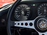 a steering wheel and dashboard of a car with a speedometer
