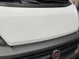 a white van parked in a parking lot next to a building