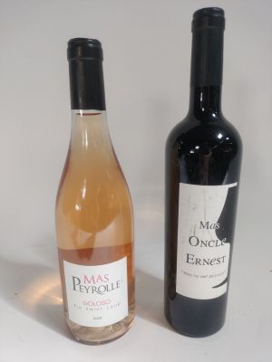 two bottles of wine sitting next to each other on a table