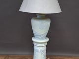 a lamp that is sitting on a wooden floor