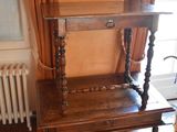 a wooden table with a shelf on it in a room