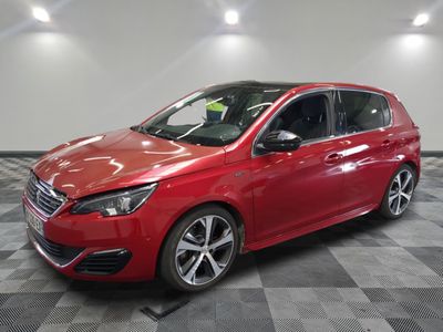 a red car parked in a garage with a checkered floor